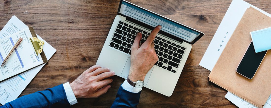 Hands pointing at laptop computer